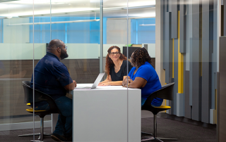 Three employees working together in a room