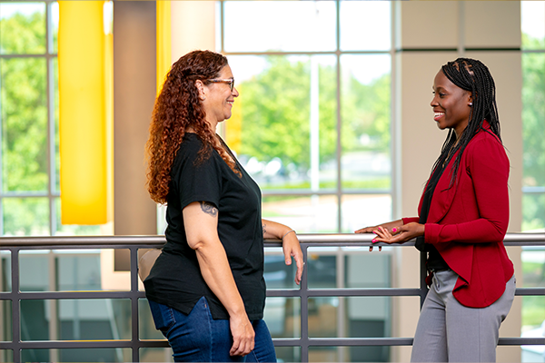 CC-1 two woman employees talking with eachother