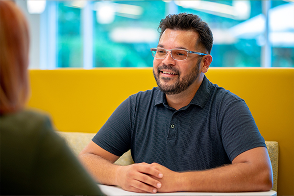 Synchrony employee sitting at table