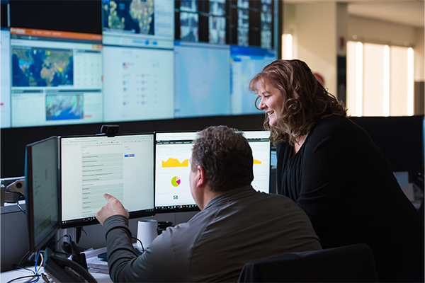 two employees working at a computer