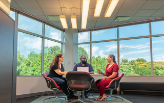 three people sitting at table