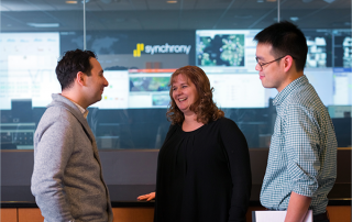 two men and women talking with one another