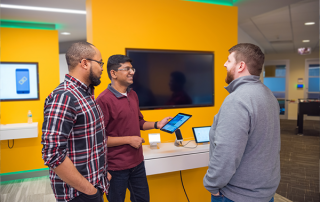 three employees working together