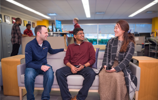 three employees sitting with each other