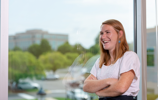 Woman with arms crossed smiling